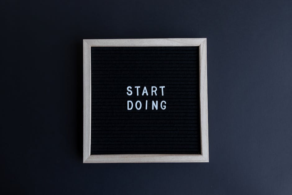 Black letter board with the motivational phrase 'Start Doing' in white text on a gray background.