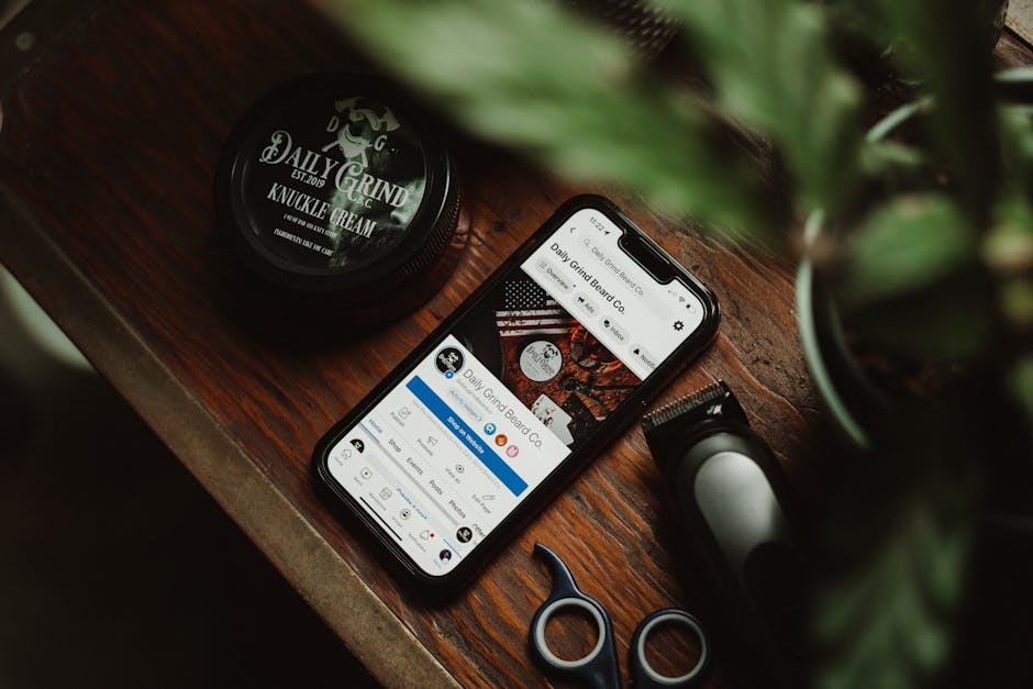 Grooming tools and smartphone with displayed brand profile on a rustic table.